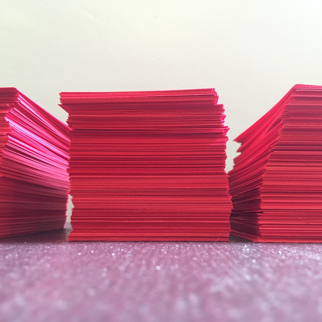 Close up image of stacks of red pre-cut paper