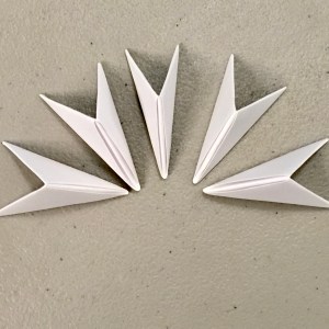Several white origami triangle units.